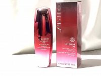 Photo showing Shiseido Ultimune Eye Power Infusing Eye Concentrate bottle alongside its matching box in red gradient design.