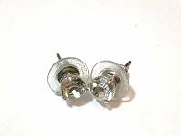 Pair of Swarovski clear crystal stud earrings with white rhodium plating shown from rear with post and backing.