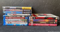 Stack of Nintendo GameCube games and several Blu-ray movies showing titles and cases