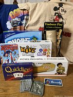 Lot overview showing games, metal molds, patch, and T-Shirts