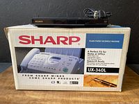 Sharp UX-340L plain paper facsimile machine in original box with phone and copier functions.
