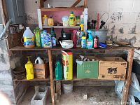 Wide shot of wooden shelf holding various garden chemical bottles, automotive products, and tools including MiracleGro, RainX, Weed Stop, lug wrench and brushes.