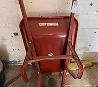 Wheelbarrow showing front metal bucket and handles, with True Temper branding detailed.