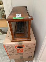 Side view of the rectangular wooden case with glass panels, showing the depth of the scale and wood grain details.