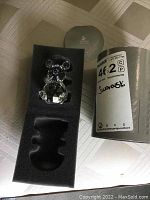 Photo of the Swarovski crystal bear in original box with certificate booklet visible