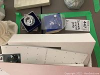 Crystal prism sphere with etched Swarovski swan logo and SCS mark in blue velvet box alongside original outer box and paperwork.