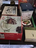 Image showing assorted boxed kitchen items including fondue set and votive holders