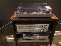 Three stacked audio components on shelving