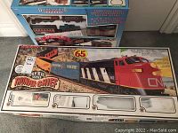 Photo showing Bachmann King of the Rail Series Thunderchief model train boxed with some locomotive and car artwork visible.