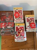 Front of 2006-07 Fleer Hockey tin and three O-Pee-Chee 2008-09 Hockey boxes showing player images and pricing information