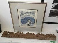 Framed blue abstract signed and numbered print with carved wooden decorative piece in front
