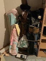 Three golf bags standing upright filled with clubs. Pink, brown, and dark blue bags visible with golf clubs.