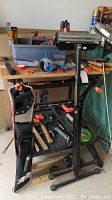 Black & Decker Workmate 400 workbench with tools on and around it, including hanging tool pouch