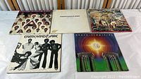 Five Earth Wind and Fire vinyl albums displayed in a row, showing their front covers and jacket wear condition.