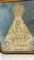 Close-up of saint figure in ornate robe and sunburst crown with inscription visible at top center.