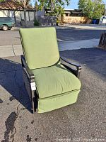 Front view of chair upright with green cushions