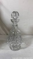Front view of the Waterford Crystal decanter with stopper, showing Lismore pattern cuts on the bowl and base.