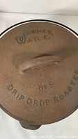 Close-up photo of the roaster lid embossed with 'Wagner Ware Drip Drop Roaster No. 9'.