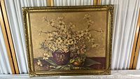 Full view of framed floral print titled 'Spring Blossoms' depicting dogwood flowers and rustic vase on table.