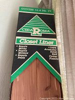 Box packaging showing coverage of 16.4 sq. ft. and product brand CedaRoma Closet Liner with red cedar plank image.