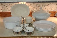 Full set of white dishware including casserole dish, tureen, pie plates, and serving platter