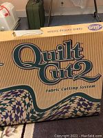Photo of Altos Quilt Cut 2 fabric cutting system in box showing branding and model name.