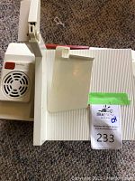 Vintage Waring thin slicer showing side vent, red button, and sliding slicing tray, placed on carpet