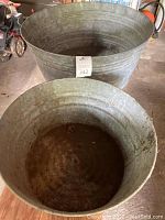 View of both galvanized washtubs from above showing their interior and sizes.