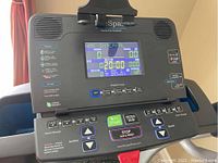 Close-up of the treadmill's digital control console showing program options, speed and incline buttons, and start/stop controls.