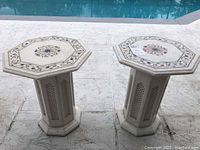 Two octagonal India marble pedestal tables side by side near pool, showing overall size and shape.