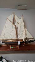 Full view of the Bluenose model ship with sails extended and mounted on stand.