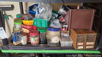 Shelf with assorted jars and containers of nails, screws, fasteners plus wooden multi-drawer organizer