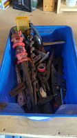 Blue plastic bin containing various tools including pipe clamp, drill bits, pliers.