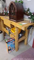 Full view of wood workbench with vintage radio on top