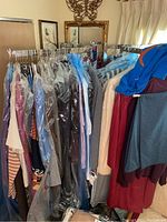 Front view of rack loaded with women's garments in protective covers