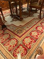 Wide view of rug under dining table showing overall pattern and condition
