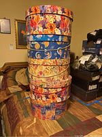 Stack of five decorative round hat boxes with floral and celestial prints