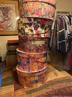 Stack of five decorative floral-pattern round hat boxes
