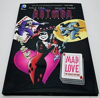 Front cover of the hardcover graphic novel with dust jacket showing Batman Adventures characters Harley Quinn and Batman, and title Mad Love Deluxe Edition.
