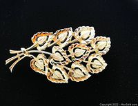 Front view of the signed Coro gold-tone leaf brooch showing the intricate leaf design and shine of metal.