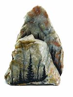 Front view of quartz-type rock with hand painted forest scene and artist signature Vasco.