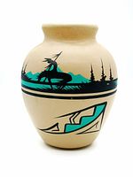 Front view of handmade Navajo pottery vase showing mounted warrior motif and geometric design in black and turquoise on beige.