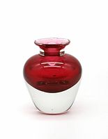 Front view of the small handblown art glass bud vase showing deep red upper glass blending into clear glass bottom.