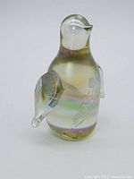 Side view of the vintage iridescent glass penguin figurine showing its wing and detailing