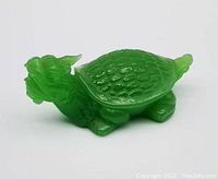 Side view of the jade green glass dragon turtle showing sculpted head and shell details.