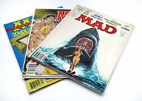 Three MAD Magazines stacked showing cover art of the top issue #204 with a woman and shark illustration