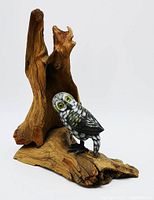 Front angle showing the owl perched on natural wood base with hollow tree trunk, detail of the owl's posture and paint work