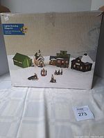Photo showing the original box with artwork depicting the eight piece lighted Christmas Scouting Village set.