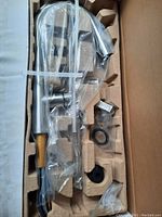 Brand new Kohler kitchen faucet and accessories in molded kraft fiber packaging inside original box, sealed plastic bags contain parts.