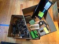 Box with tangled charging cords and adapters.